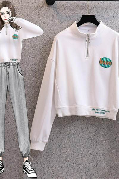 Rövid női pulóver cipzárral és színes mintával