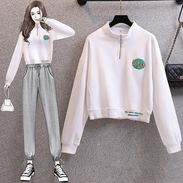 Rövid női pulóver cipzárral és színes mintával