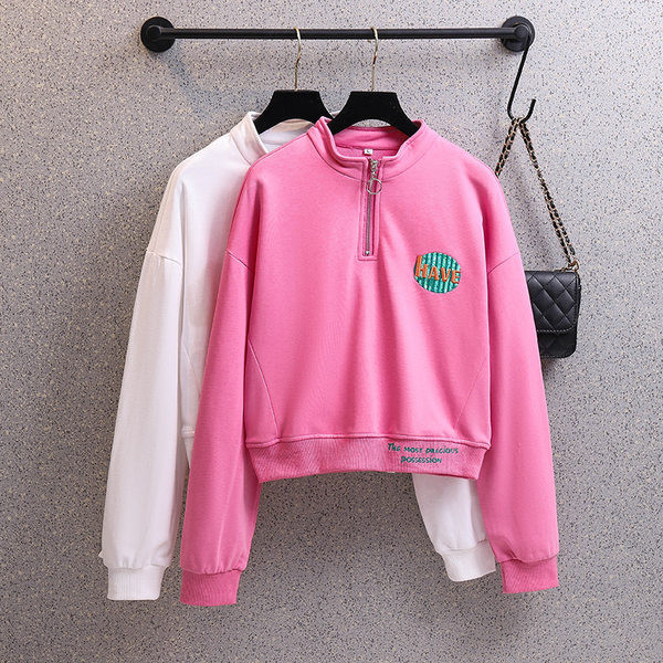 Rövid női pulóver cipzárral és színes mintával