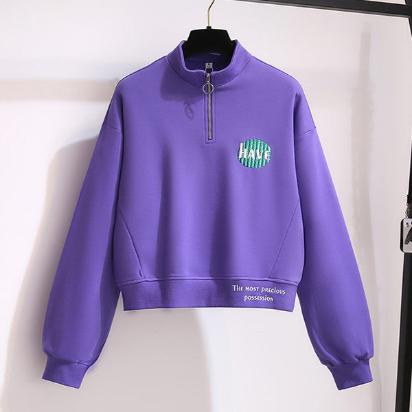 Rövid női pulóver cipzárral és színes mintával