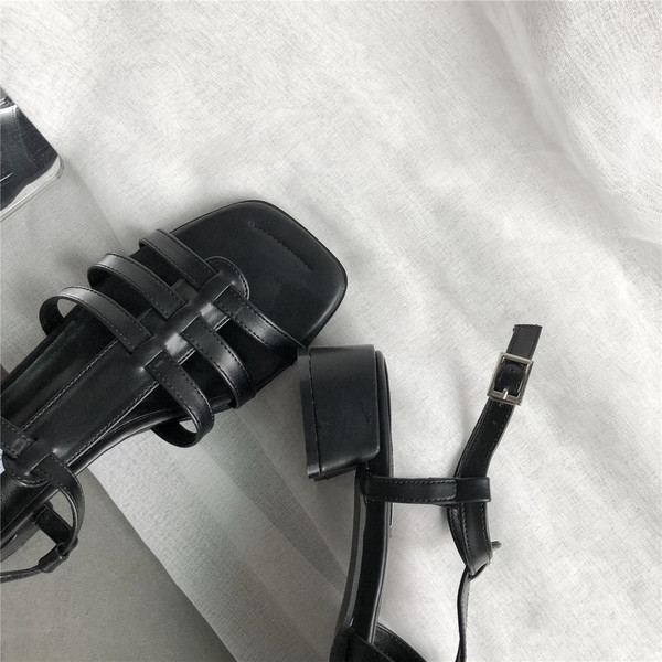 Valge ja musta värvi nahast rihmadega vabaaja sandaalid