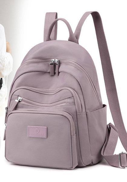 Naiste tekstiilist seljakott taskutega mitmes värvitoonis