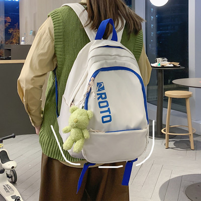 Naiste tekstiilist seljakott kirja ja aplikatsiooniga