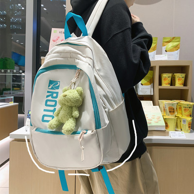 Naiste tekstiilist seljakott kirja ja aplikatsiooniga