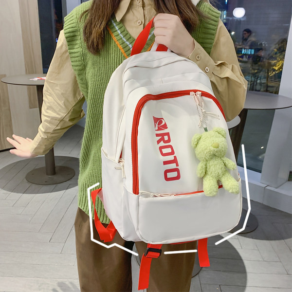 Naiste tekstiilist seljakott kirja ja aplikatsiooniga