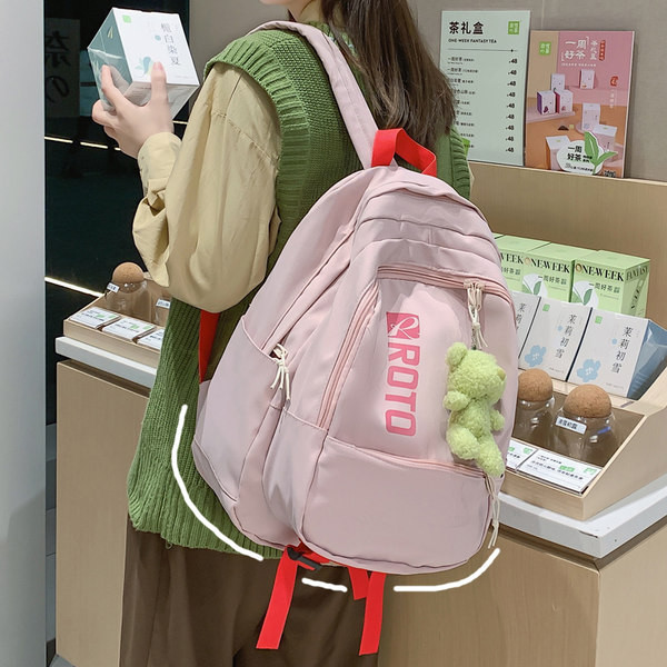 Naiste tekstiilist seljakott kirja ja aplikatsiooniga