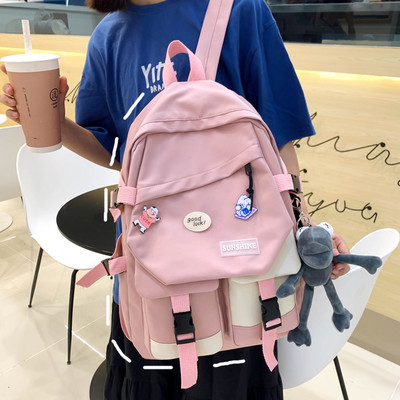 Taskute ja embleemiga lõuendist käekott