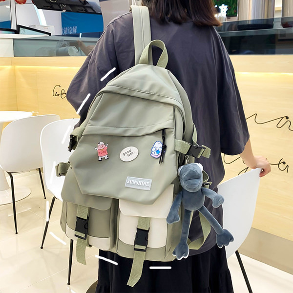 Taskute ja embleemiga lõuendist käekott