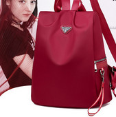 Naiste tekstiilist seljakott mitmes värvitoonis embleemiga