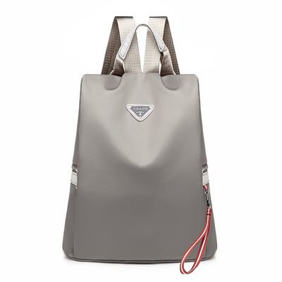 Naiste tekstiilist seljakott mitmes värvitoonis embleemiga