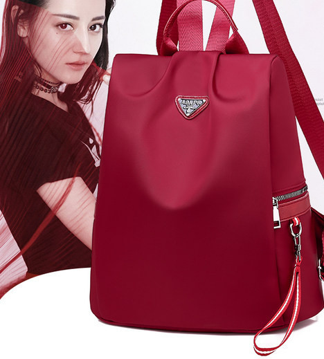 Naiste tekstiilist seljakott mitmes värvitoonis embleemiga