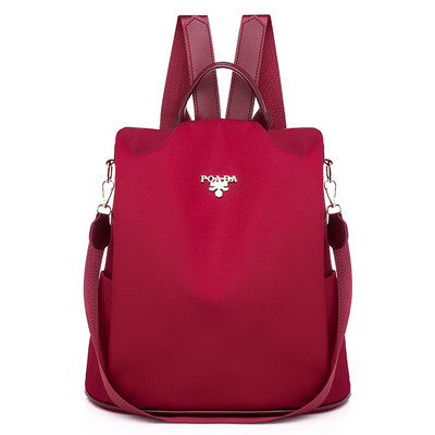 Női vászon hátizsák fém emblémával piros és fekete színben