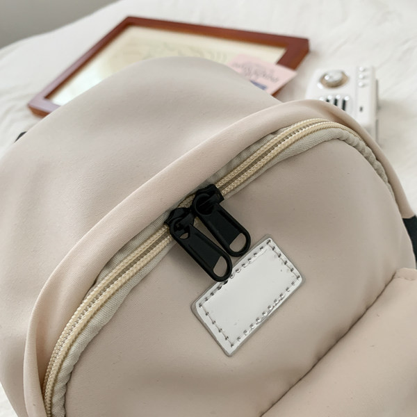 Väike naiste tekstiilist taskuga seljakott