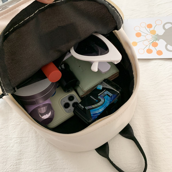 Väike naiste tekstiilist taskuga seljakott