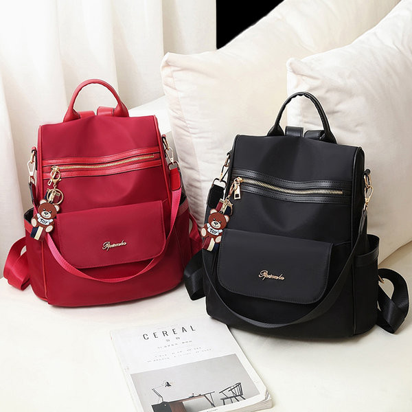 Naiste stiilne seljakott, millel on ees tõmblukk ja kiri