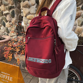 Tekstiilist seljakott neljas värvitoonis kirjadega