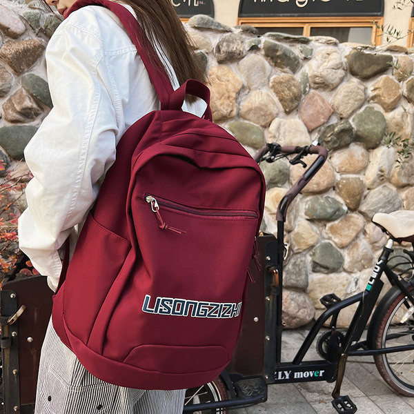 Tekstiilist seljakott neljas värvitoonis kirjadega