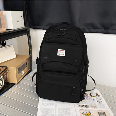 Naiste tekstiilist seljakott tasku ja embleemiga