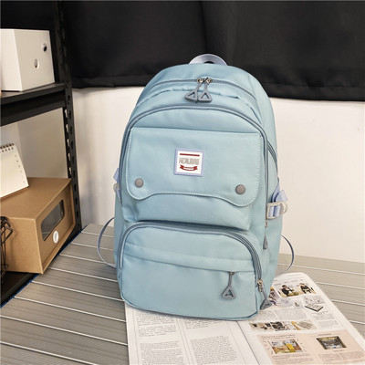 Naiste tekstiilist seljakott tasku ja embleemiga