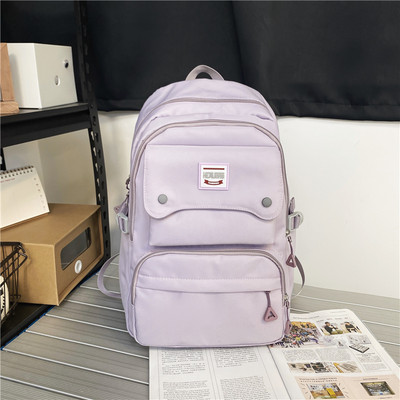 Naiste tekstiilist seljakott tasku ja embleemiga