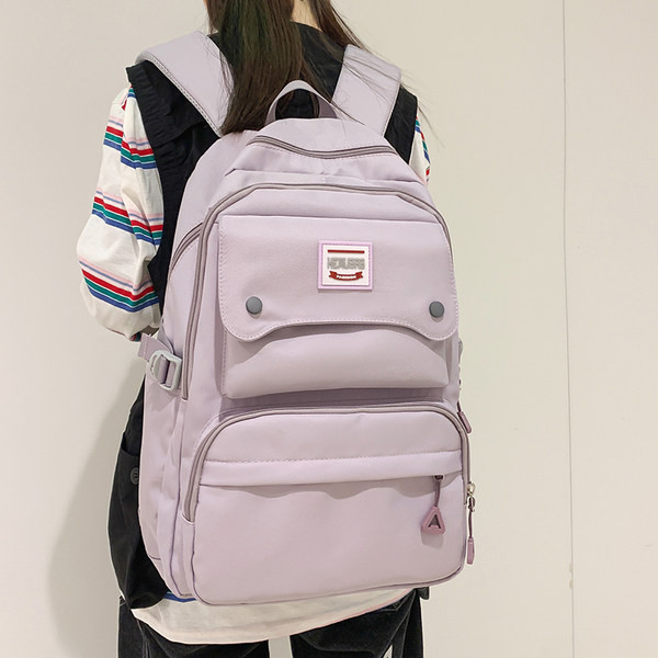 Naiste tekstiilist seljakott tasku ja embleemiga