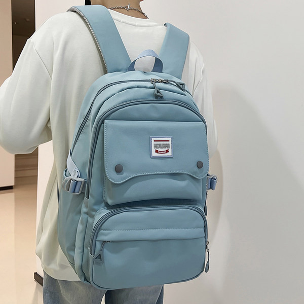 Naiste tekstiilist seljakott tasku ja embleemiga