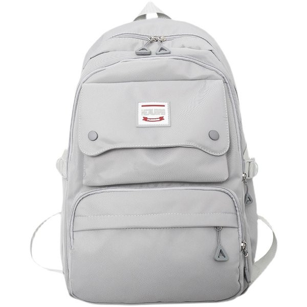 Naiste tekstiilist seljakott tasku ja embleemiga