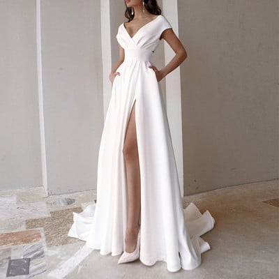 Formal women`s long dress with a slit in white