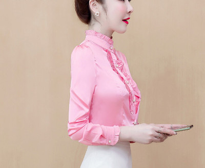 Modern women`s shirt with curls and pearl buttons