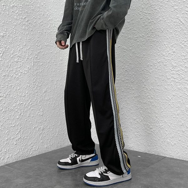 Naistele pikad spordipüksid küljeäärega