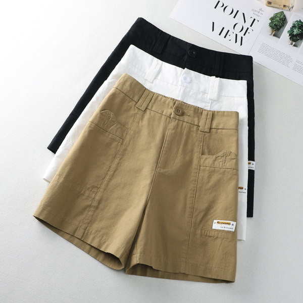 Taskute ja embleemiga vabaajapüksid