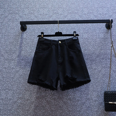 Naiste lühikesed kõrge vöökoha ja rebenenud motiividega teksapüksid