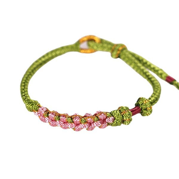 Ležerna ženska narukvica od tekstila sa privjeskom