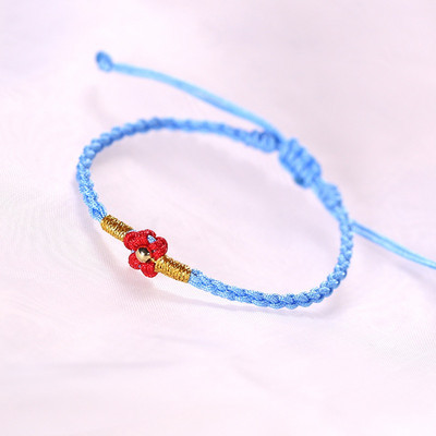 Ženska tekstilna narukvica sa cvijetom