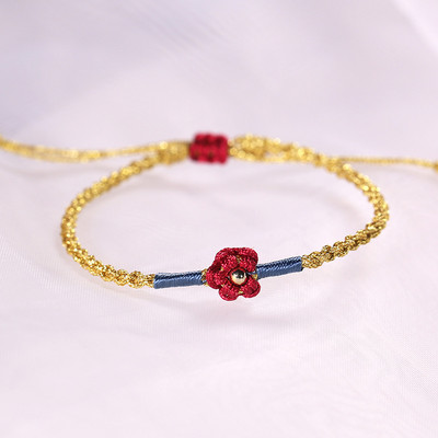 Ženska tekstilna narukvica sa cvijetom