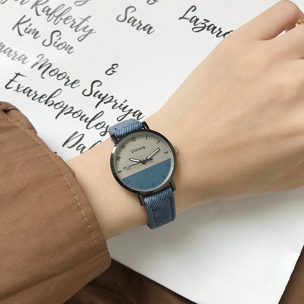 Ženski okrugli sat s tekstilnim remenom