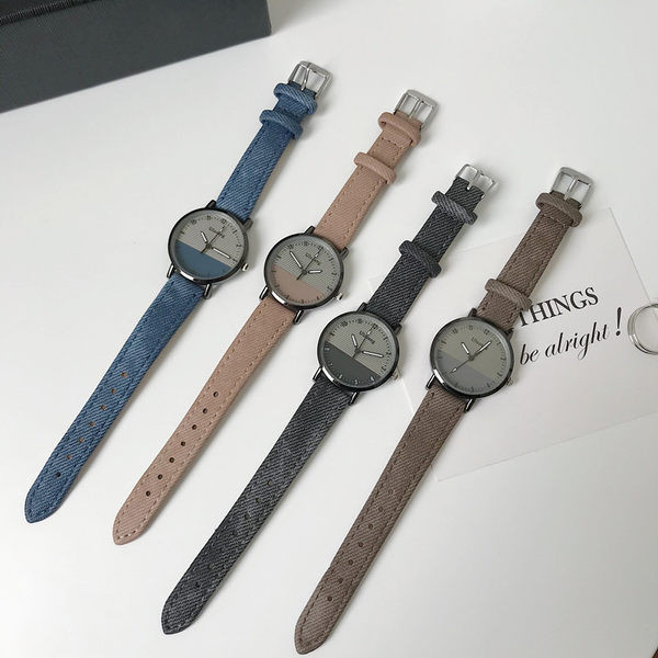 Ženski okrugli sat s tekstilnim remenom