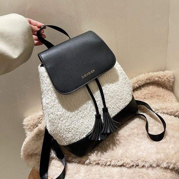 Tekstiilist ja ökonahast naiste seljakott kirjaga