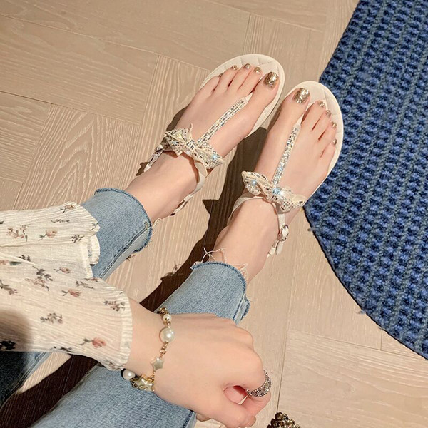 Ženske sandale između vrhova sa ukrasnim kamenčićima i metalnom kopčom